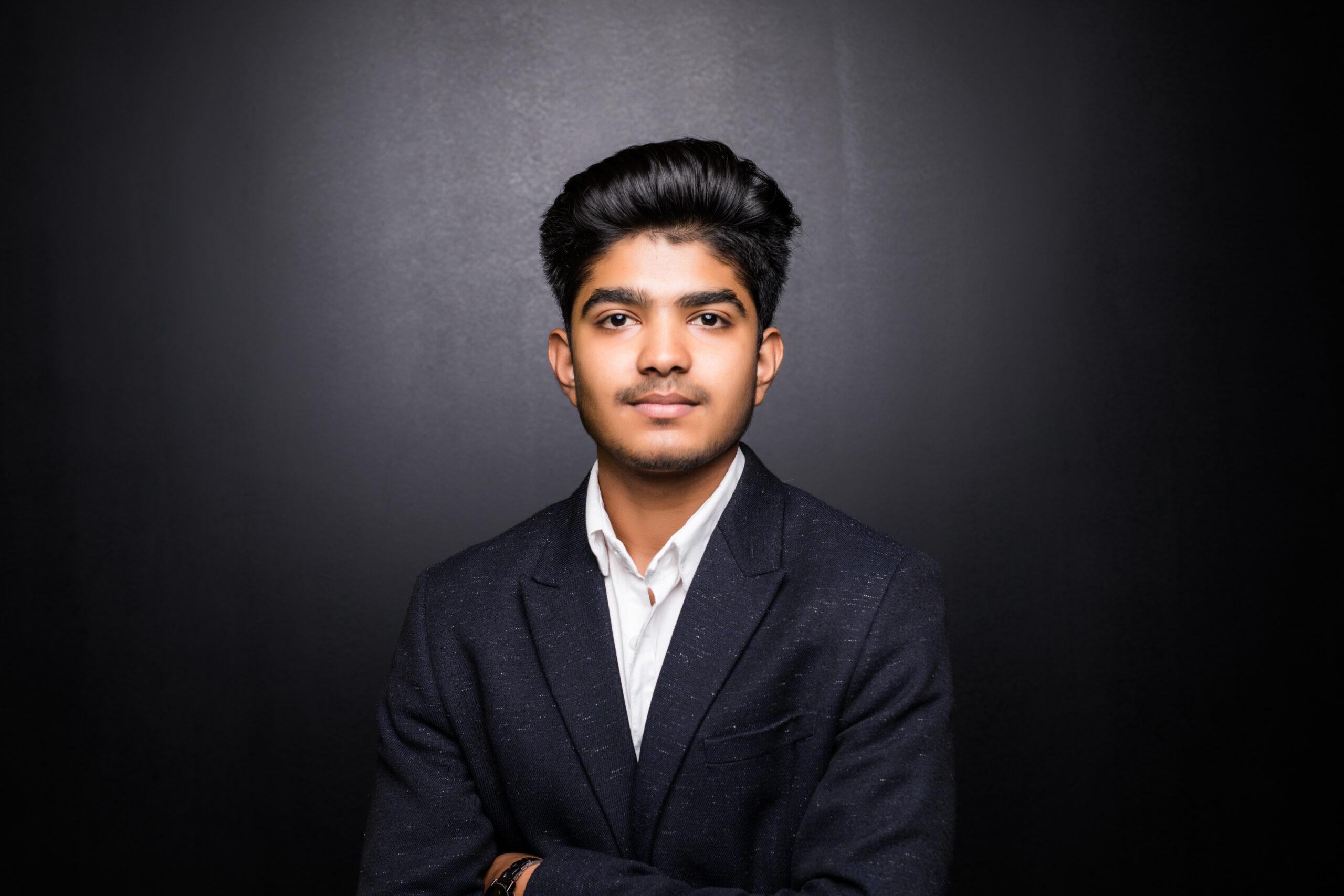 Indian business man with crossed arm on dark background,