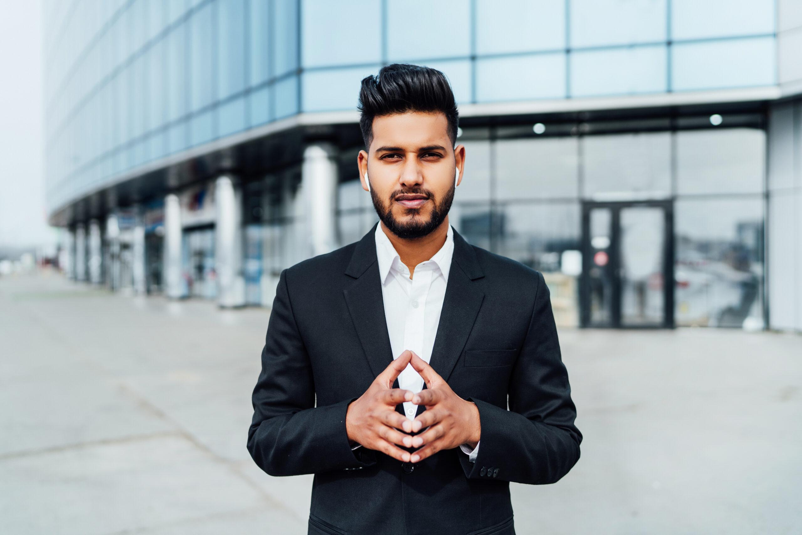 Portrait of a serious smiling modern Indian man, businessman, in